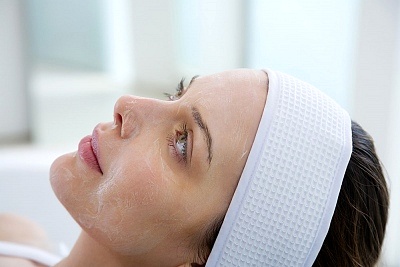 Chemical peel treatment process showing a person receiving the treatment.